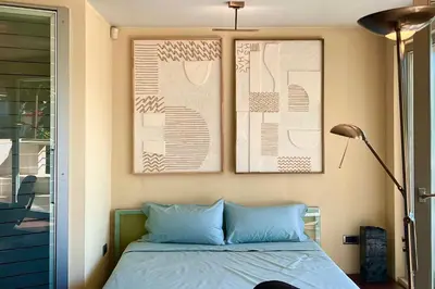 a bedroom with a bed with two pictures on the wall at Nostalgic '90s Place Historical Center in Sofia