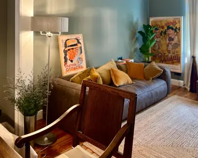 a living room with a couch with pillows on it at Laurel & Hardy - Old city center Apart in Sofia