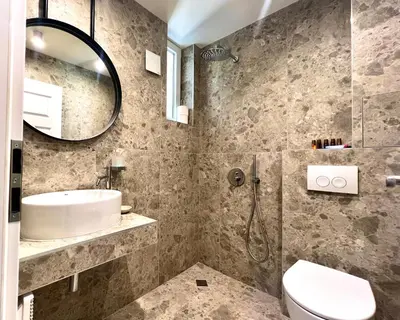 a bathroom with a sink and a toilet and a mirror at Laurel & Hardy - Old city center Apart in Sofia