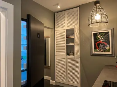a hallway with white shutters on a wall at Laurel & Hardy - Old city center Apart in Sofia