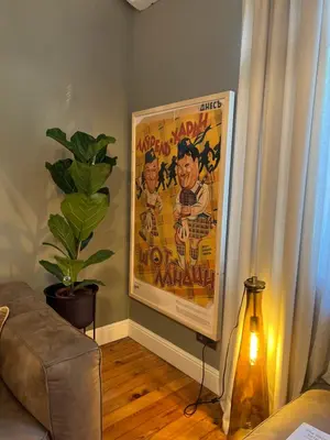 a living room with a movie poster on the wall at Laurel & Hardy - Old city center Apart in Sofia