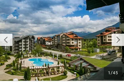 a resort with a swimming pool and some buildings at Aspen Golf Resort and SPA, Studio J006 in Bansko