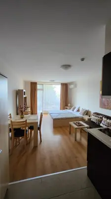 a living room with a couch and a table at Aspen Golf Resort and SPA, Studio J006 in Bansko