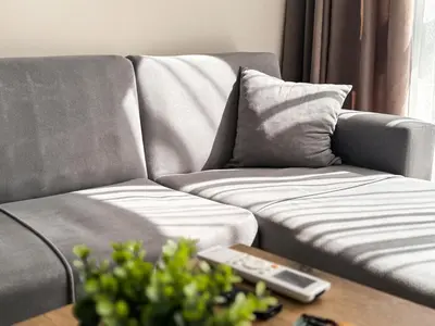 a living room with a couch and a coffee table at Modern 1BR Apartment with Free Street Parking and free Gym Pass in Plovdiv