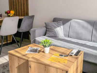 a living room with a couch and a coffee table at Modern 1BR Apartment with Free Street Parking and free Gym Pass in Plovdiv