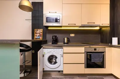 a kitchen with a washing machine and a microwave at Modern and Cozy 1BD in the Top Centre of Plovdiv by Flat Mаnager in Plovdiv