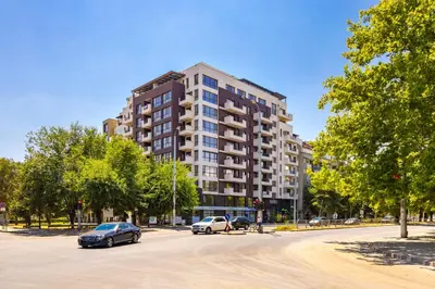 a parking lot with cars parked in front of a building at Modern and Cozy 1BD in the Top Centre of Plovdiv by Flat Mаnager in Plovdiv