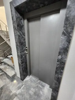 a elevator door in a room with marble floors at V&S Home in Plovdiv