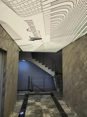 a hallway with a ceiling with a spiral staircase at V&S Home in Plovdiv
