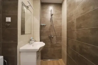 a bathroom with a sink and a shower at New Sofia Skyline 1BDRM Free Parking & Terrace in Sofia