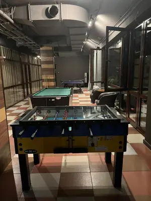 a room with a ping pong table in the middle at Borovets Gardens Apartment B15 in Borovets