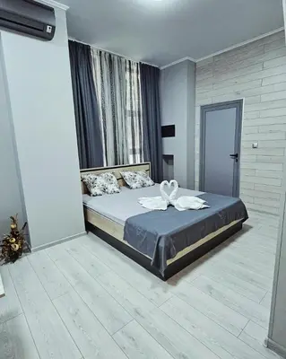 a bedroom with a large bed in a room at Апартаменти за гости Кедър in Sapareva Banya