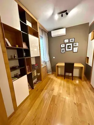 a room with a desk and a table and a shelf at City Center Spacious 2BR near Vitosha Blvd in Sofia