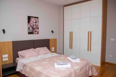 a bedroom with a bed with two phones on it at City Center Spacious 2BR near Vitosha Blvd in Sofia