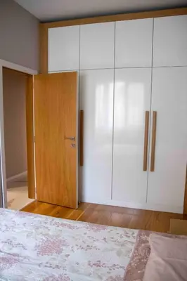 a bedroom with white cabinets and a bed at City Center Spacious 2BR near Vitosha Blvd in Sofia