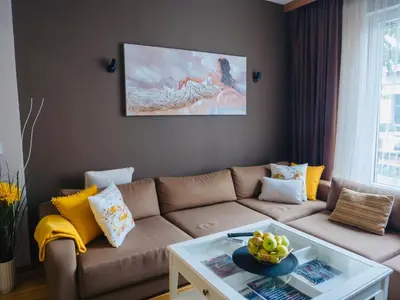a living room with a couch and a table at City Center Spacious 2BR near Vitosha Blvd in Sofia