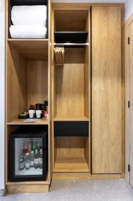 a cupboard with drinks in it in a room at AMAR Design Hotel by HMG in Sofia