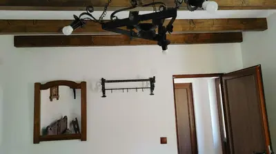 a chandelier hanging from a ceiling next to a mirror at Вила Идилия in Ribarica
