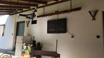 a flat screen tv hanging on a wall at Вила Идилия in Ribarica