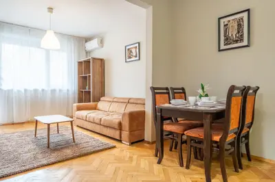 a living room with a table and a couch at Pirotska 2-Bedroom 100m2 Apartment in Sofia Center in Sofia