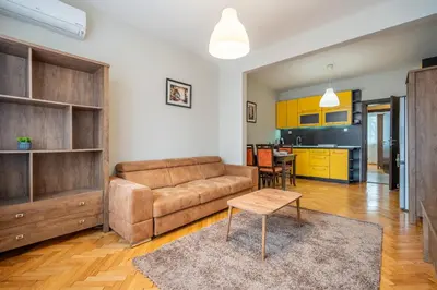 a living room with a couch and a table at Pirotska 2-Bedroom 100m2 Apartment in Sofia Center in Sofia
