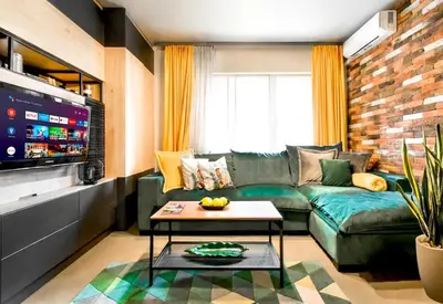 a living room with a green couch and a table at Compact Studio for Digital Nomads, Fast WiFi, AC in Sofia