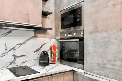 a kitchen with a stove and a microwave at Compact Studio for Digital Nomads, Fast WiFi, AC in Sofia