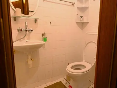 a bathroom with a toilet and a sink at Urban Oasis Studio in Sofia