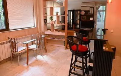 a dining room with a table and chairs at Urban Oasis Studio in Sofia