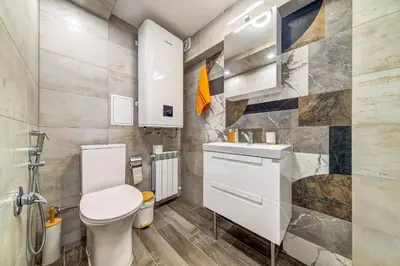 a bathroom with a toilet and a sink at Rhodope Escape - Modern 1BR Apartment with Balcony & Free Parking in Smolyan