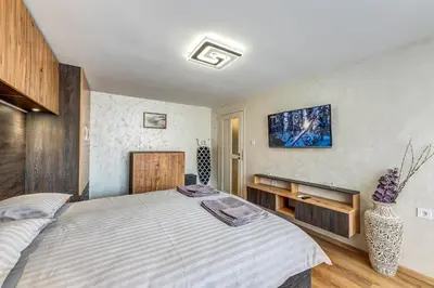 a bedroom with a large bed in a room at Rhodope Escape - Modern 1BR Apartment with Balcony & Free Parking in Smolyan
