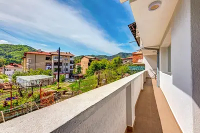 a balcony with a view of a city at Rhodope Escape - Modern 1BR Apartment with Balcony & Free Parking in Smolyan
