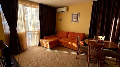 a living room with a couch and a table at Апартаменти Хармония in Pamporovo