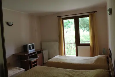 a hotel room with two beds and a window at By the River Hotel Complex in Balkanets