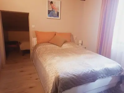 a bed with orange pillows in a bedroom at Костовският хан in Chepelare