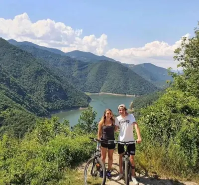 a man and woman standing next to their bikes on a mountain at Spa Villas Daffi in Smolyan