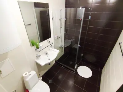 a bathroom with a shower and a toilet and a sink at Aspen Apartment A212 3OOm from Gondola in Bansko