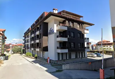 a building with a sign on the side of it at Aspen Apartment A212 3OOm from Gondola in Bansko