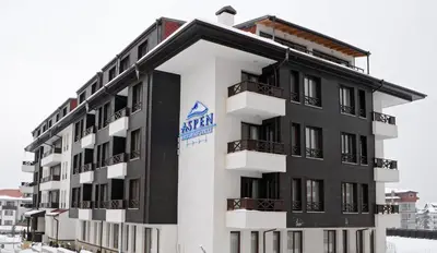 a building with a sign on the side of it at Aspen Apartment A212 3OOm from Gondola in Bansko
