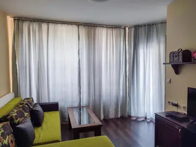 a living room with a couch and a table at Aspen Apartment A212 3OOm from Gondola in Bansko
