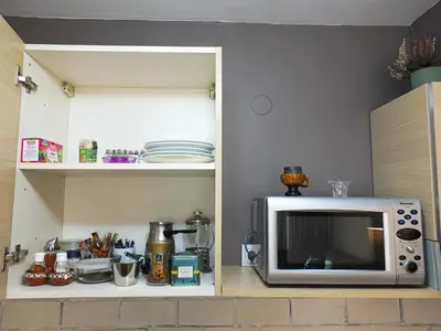 a microwave sitting on top of a kitchen counter at The snug apartment near the brimming mountains in Bansko