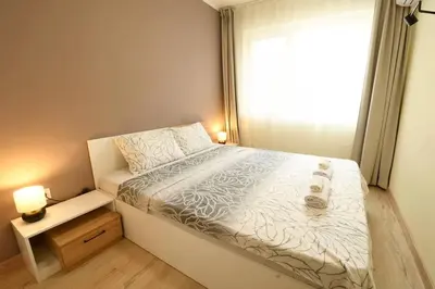 a small bedroom with a bed and a window at INB Banishora Spot in Sofia