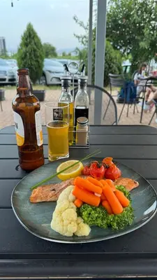 a plate of food with vegetables on a table at Apartments Sofia Airport free shuttle and parking in Sofia