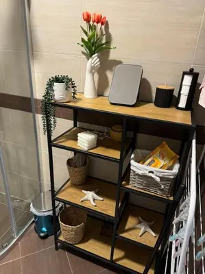 a shelf with a vase of flowers and a plant at Anna Lux in Bansko