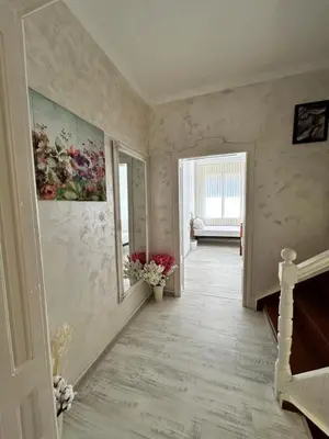 a hallway with a painting of flowers on the wall at Smile House in Plovdiv