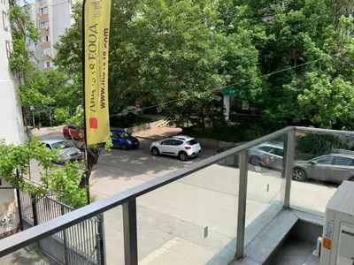 a view of a parking lot from a balcony at Kirmini apartment in Sofia