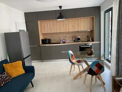 a kitchen with a glass table and chairs in a room at Kirmini apartment in Sofia