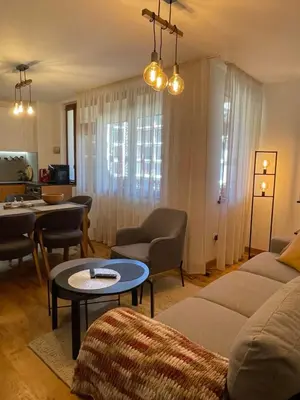 a living room with a couch and a table at Borovets Boutique Apartment Sequoia II in Borovets