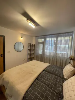 a bedroom with a large bed and a window at Borovets Boutique Apartment Sequoia II in Borovets