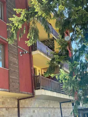 an apartment building with a balcony and a door at Borovets Boutique Apartment Sequoia II in Borovets